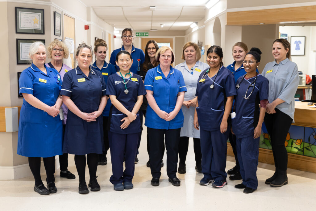 Heart of Kent Hospice clinical colleagues standing in the Inpatient Unit reception.
