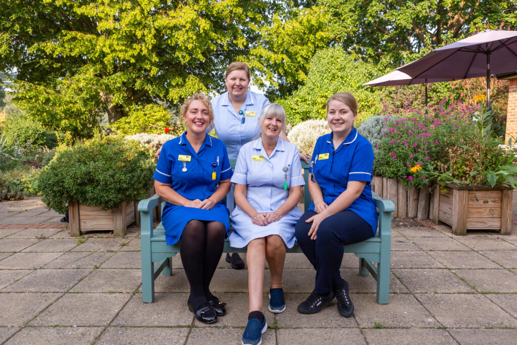 Heart of Kent Hospice nurses sat in the Hospice garden