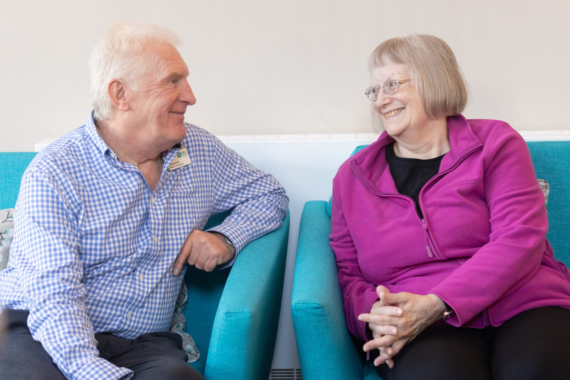 Hub_drop_in_Volunteer_Bill_chatting_to_a_patient_action_shot_March_2023