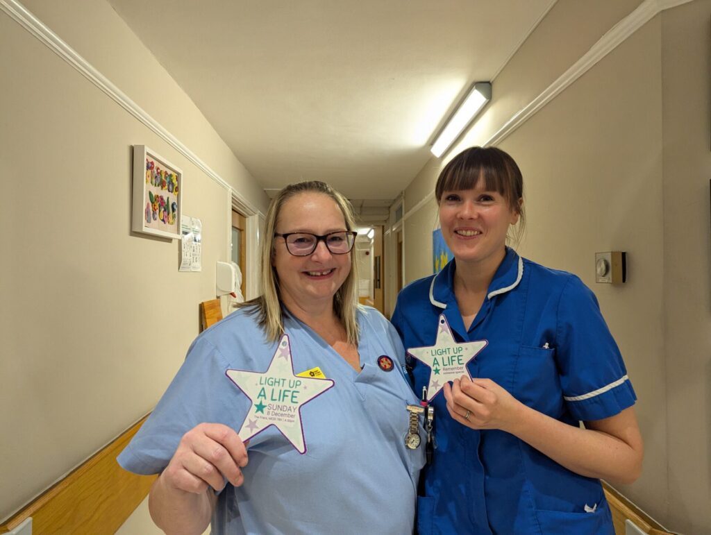 Heart of Kent Hospice Inpatient Unit holding two Light up a Life stars.