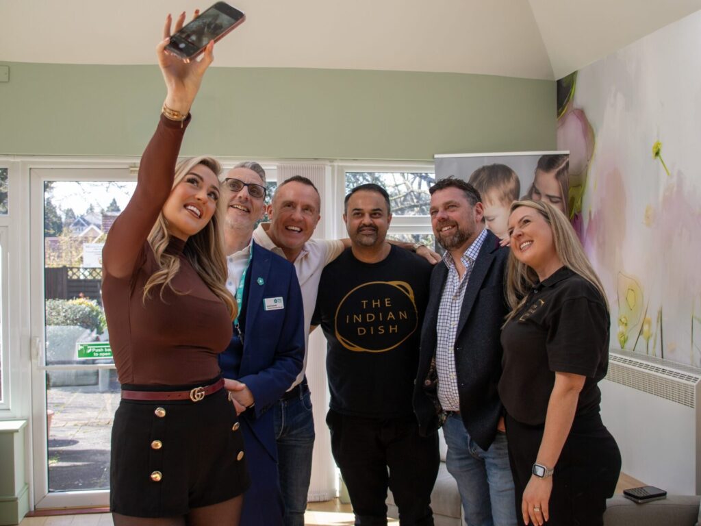 The teams at The Indian Dish, Edenwood Place, Midas Waste Management and Amber H Music holding a cheque donation of funds raised from their event
